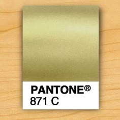 the pantone logo is shown on top of a wooden surface with a brown color