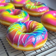 Add a pop of color to your day with these Tie-Dye Rainbow Donuts! Swirled with vibrant shades and topped with a sweet glaze, these baked donuts are perfect for birthdays, brunches, or just a cheerful treat. Easy to make and fun to decorate, they're a hit with kids and adults alike! 🎉🍭 Tie Dye Donuts, Colorful Doughnuts, Tie Dye Bagels, Tie-dye Donut Design, Colorful Tie-dye Donuts, Colorful Marbled Donuts, Rainbow Tie-dye Donuts, Colorful Tie-dye Dessert, Colorful Tie-dye Donuts With Sprinkles