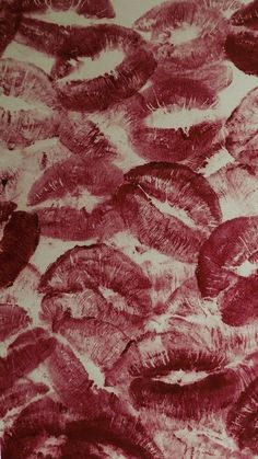 a bunch of fish that are in the water with red ink on it's surface