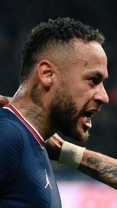 a soccer player with his arm around another player's neck