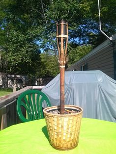 a potted plant sitting on top of a table next to a green plastic chair