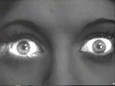 the eyes of a woman are shown in black and white