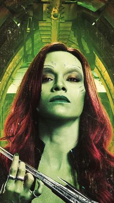 a woman with red hair and green makeup