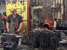 a man working in a shop with lots of tools