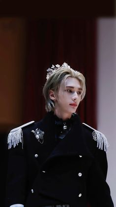 a woman with blonde hair wearing a black jacket