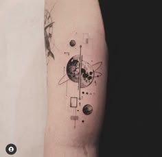 an arm tattoo with different planets and lines on the left side of the arm,