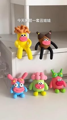 five toy animals sitting on top of a white shelf