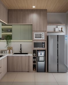 a modern kitchen with wood paneling and stainless steel refrigerator freezer, dishwasher and sink