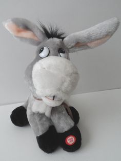 a stuffed donkey sitting on top of a white table