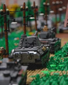 lego army vehicles are lined up on the ground