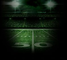 an american football field at night with the lights on