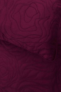 a close up view of a purple quilt
