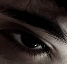 a woman's eye is shown with long lashes