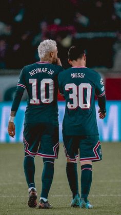 two soccer players standing next to each other