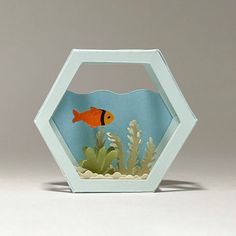 an origami fish is in the aquarium