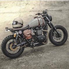 a motorcycle parked on top of a dirt field