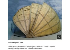 a large wooden object sitting on top of a white table next to a blue sky