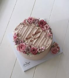 a birthday cake with pink roses on top