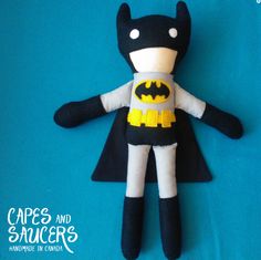 a stuffed batman doll on a blue background
