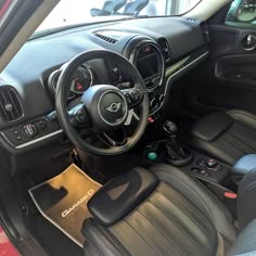 the interior of a small car with black leather seats