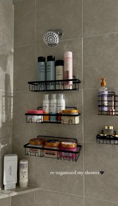 the shelves in the shower are organized with shampoos and lotion bottles on them