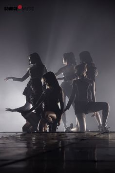 a group of women standing on top of a stage