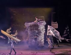 the performers are performing on stage with their surfboards