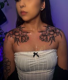 a woman with black flowers on her chest