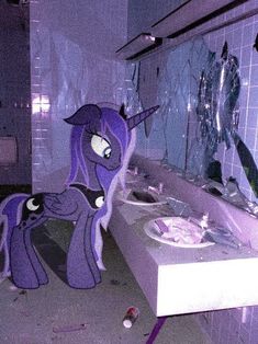 the bathroom is decorated in purple and has an image of a pony on the wall