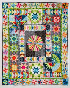 a colorful quilt is hanging on the wall