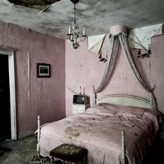 an old fashioned bedroom with pink walls and furniture