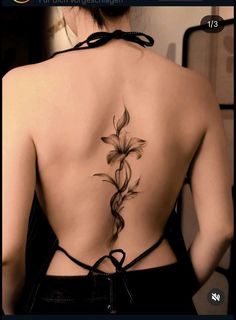 the back of a woman's body with flowers on it, and an arrow in the center