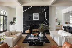 a living room filled with furniture and a fire place in the middle of a room