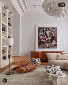 a living room filled with furniture and a chandelier