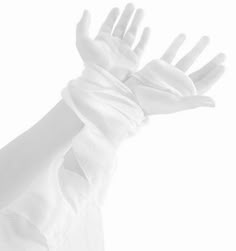 a white glove is being held up in the air