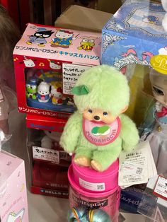stuffed animals and toys are on display at a toy store in japan, with other boxes behind them