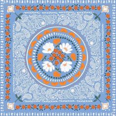 an orange and white flowered bandanna on a blue background with paisley designs in the center