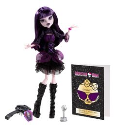 a doll with purple hair and black dress next to a book, scissor and scissors