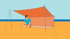 a man sitting in front of a tent on the beach next to an orange wall