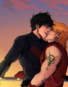 two people kissing each other in front of a sky with the sun setting behind them