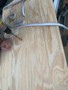 a person cutting wood with a pair of scissors