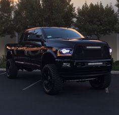 a large black truck parked in a parking lot