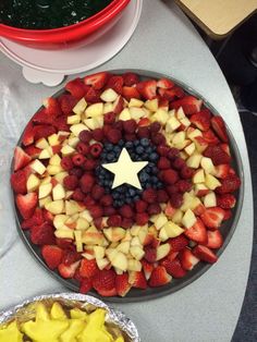 a platter filled with fruit and topped with a star