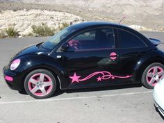 a black car with pink stars painted on it