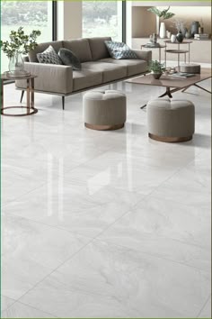 a living room with white tile floors and furniture in the center, surrounded by large windows