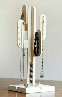 a jewelry stand made out of wood with the words how to make a modern cactus jewelry stand
