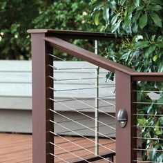 a close up of a metal railing on a wooden deck
