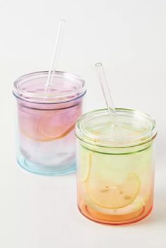 two glass jars filled with liquid and straws