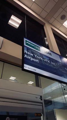 an airport sign hanging from the side of a building