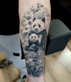 a person with a panda bear tattoo on their arm and the image of an animal